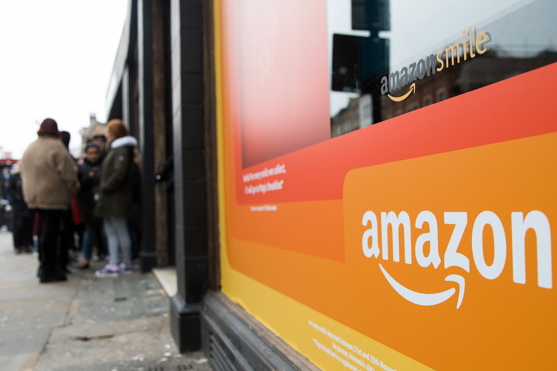 Shoppers queue to enter the Amazon.com Inc. Black Friday pop-up store on Shoreditch High Street in London, U.K., on Thursday, Nov. 22, 2018. Deloitte expects sales from November to January to rise as much as 5.6 percent, to more than $1.1 trillion, marking the best holiday period in recent memory. Photographer: Chris Ratcliffe/Bloomberg