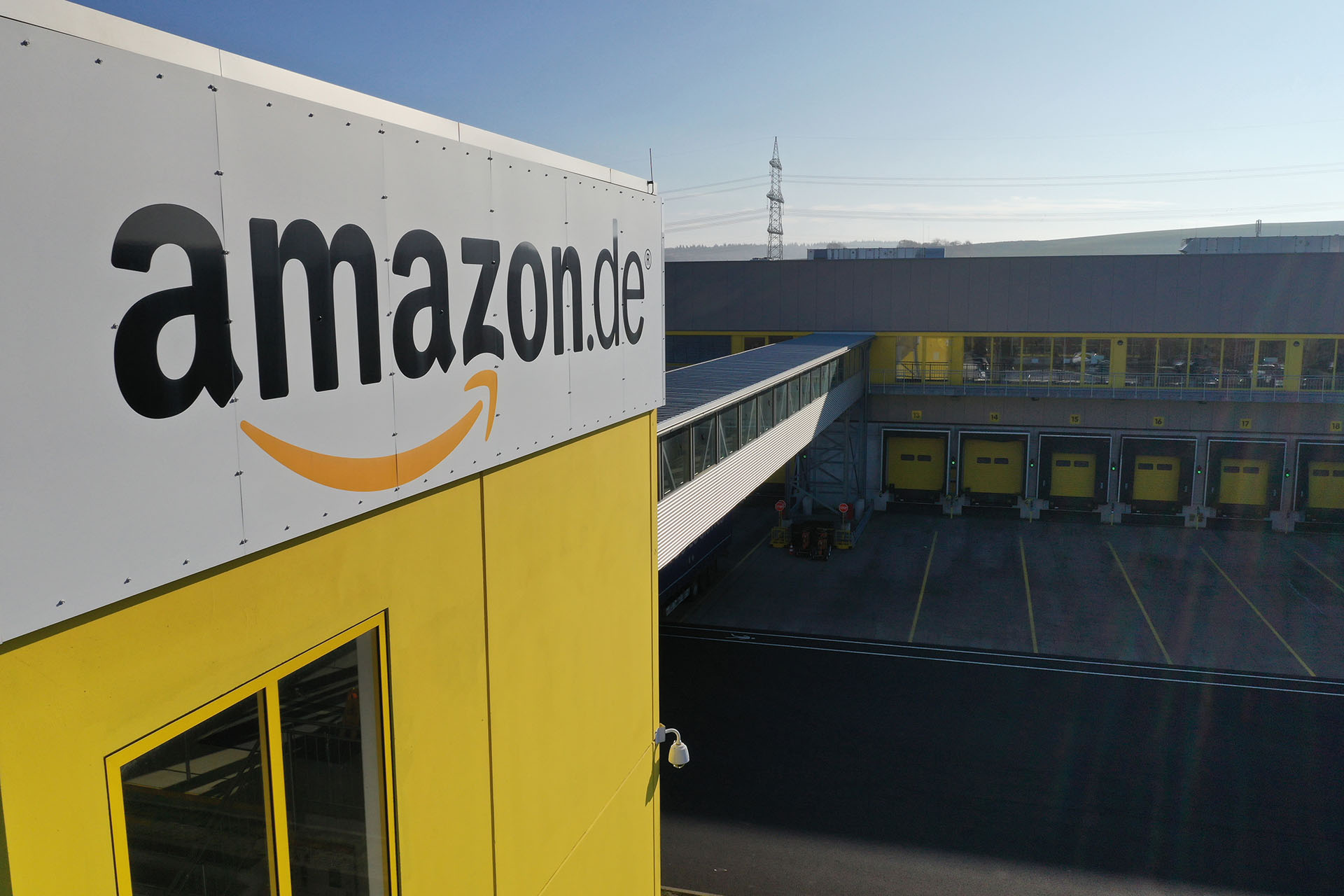An Amazon.com Inc. logo sits on the exterior of the company's fulfilment center in Koblenz, Germany, on Friday, Nov. 23, 2018. Germans are expected to buy about 2.4 billion euros worth of goods on Black Friday and Cyber Monday, an increase of about 15 percent over last year. Photographer: Alex Kraus/Bloomberg